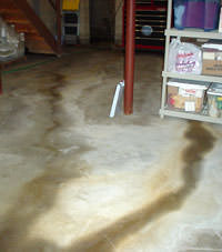Flooding entering a basement through a floor crack in Pitt Meadows