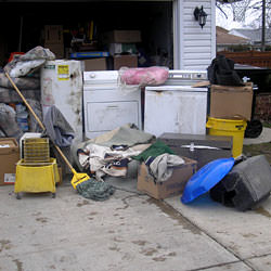 Soaked, wet personal items sitting in a driveway, including a washer and dryer in Delta.